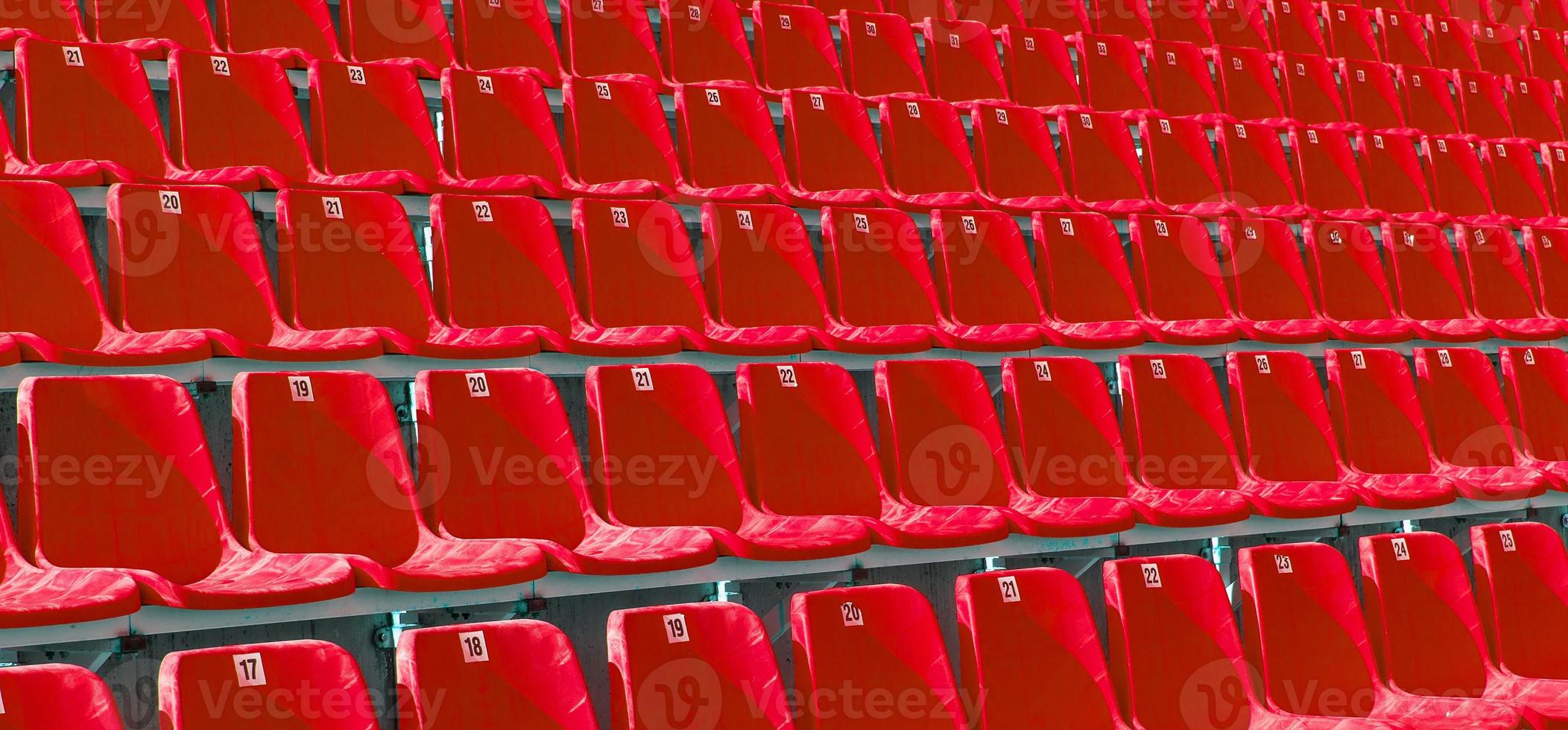 Folded blue plastic chairs on a temporary tribune. photo