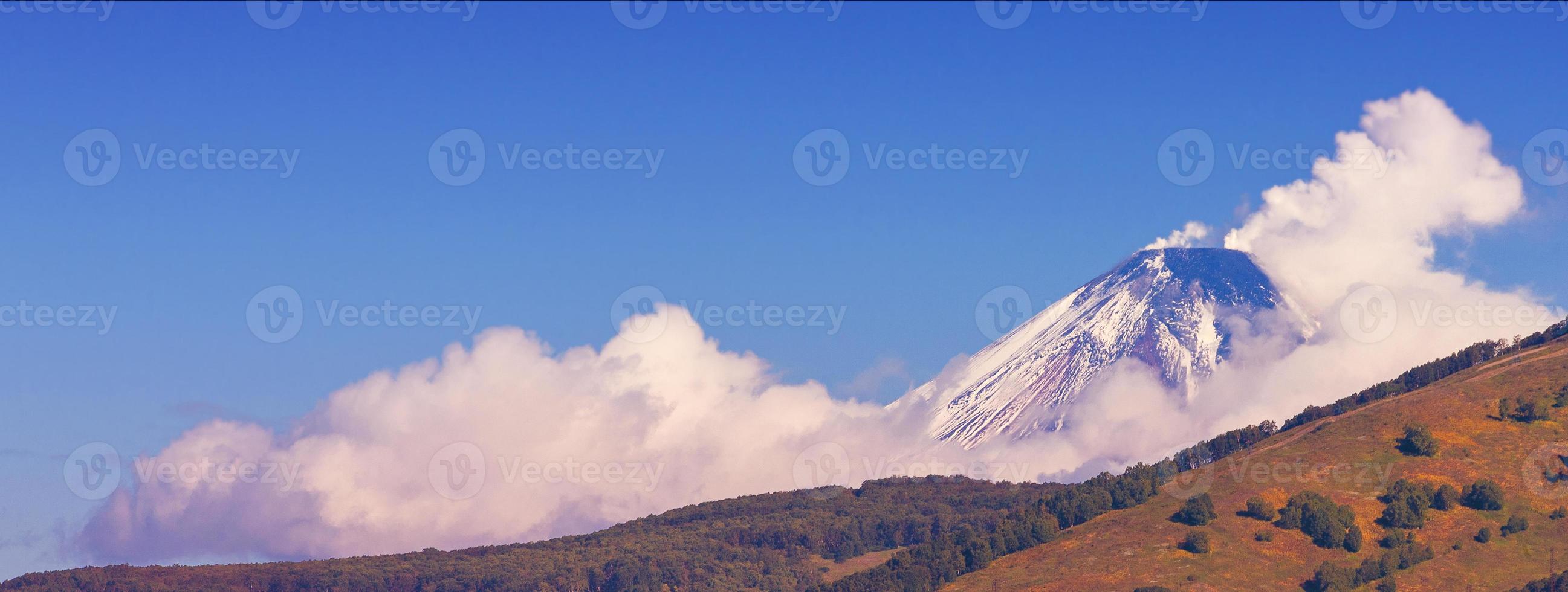 Panoramic view of snow volcano and blue sky photo