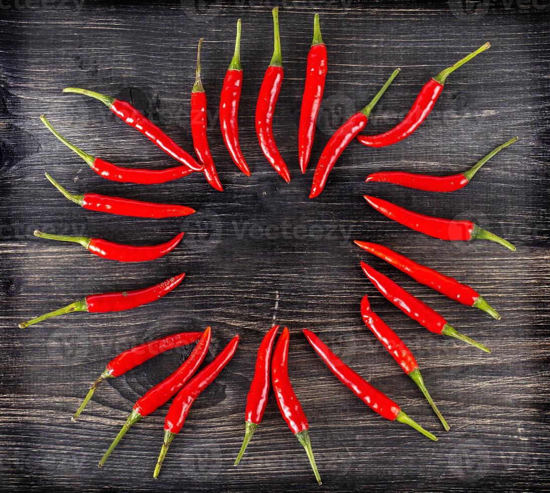 top view of spicy red chili pepper on wooden surface.Selective focus photo