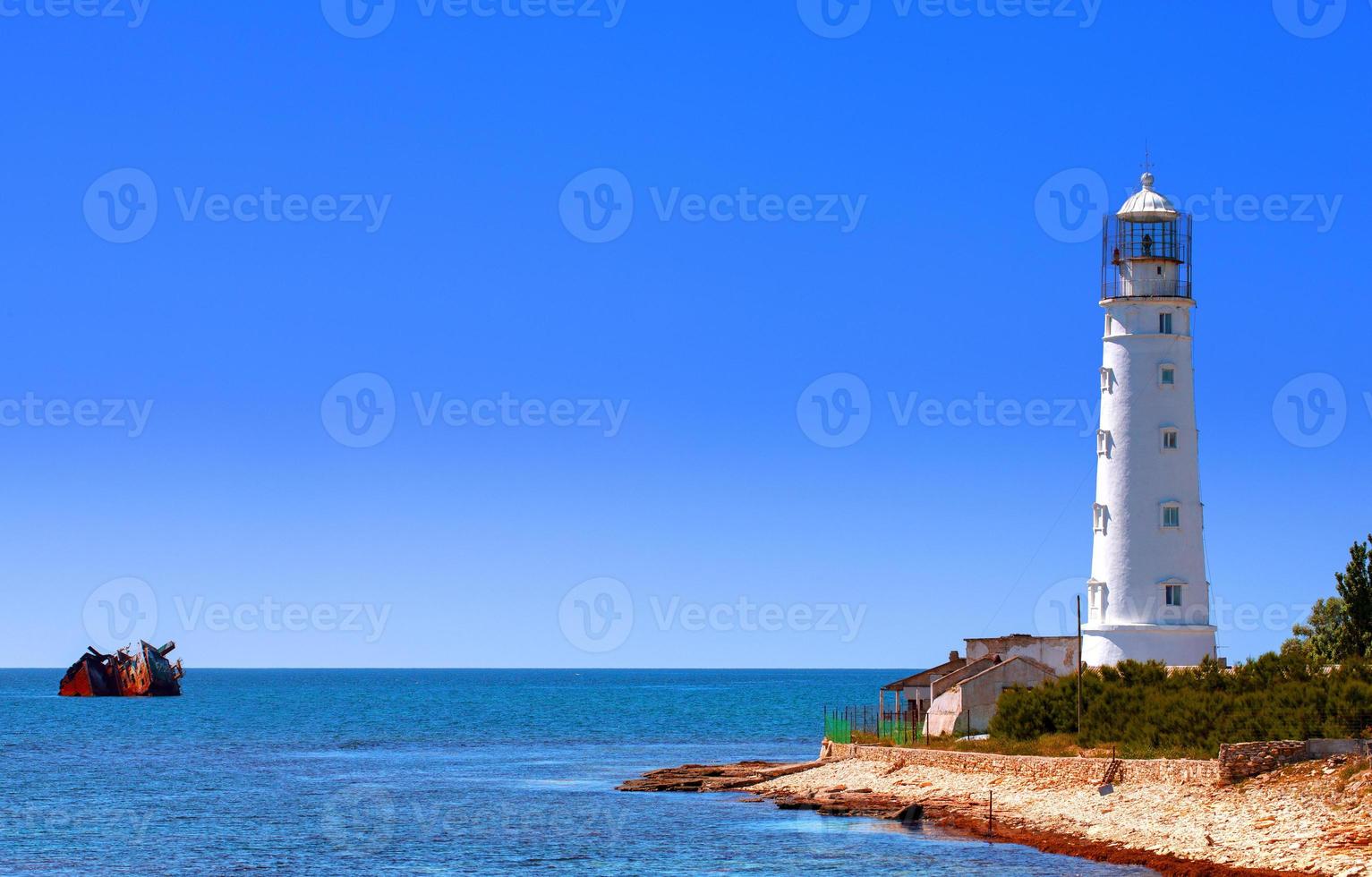 Lovely white lighthouse on the coast of the Black sea photo