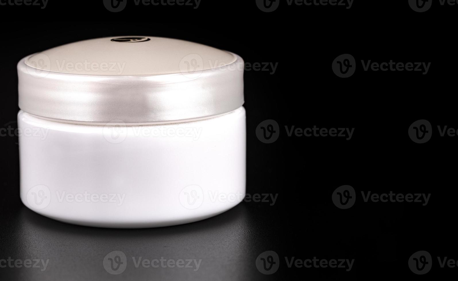 Beauty Cream Containers on Black Background Close up photo