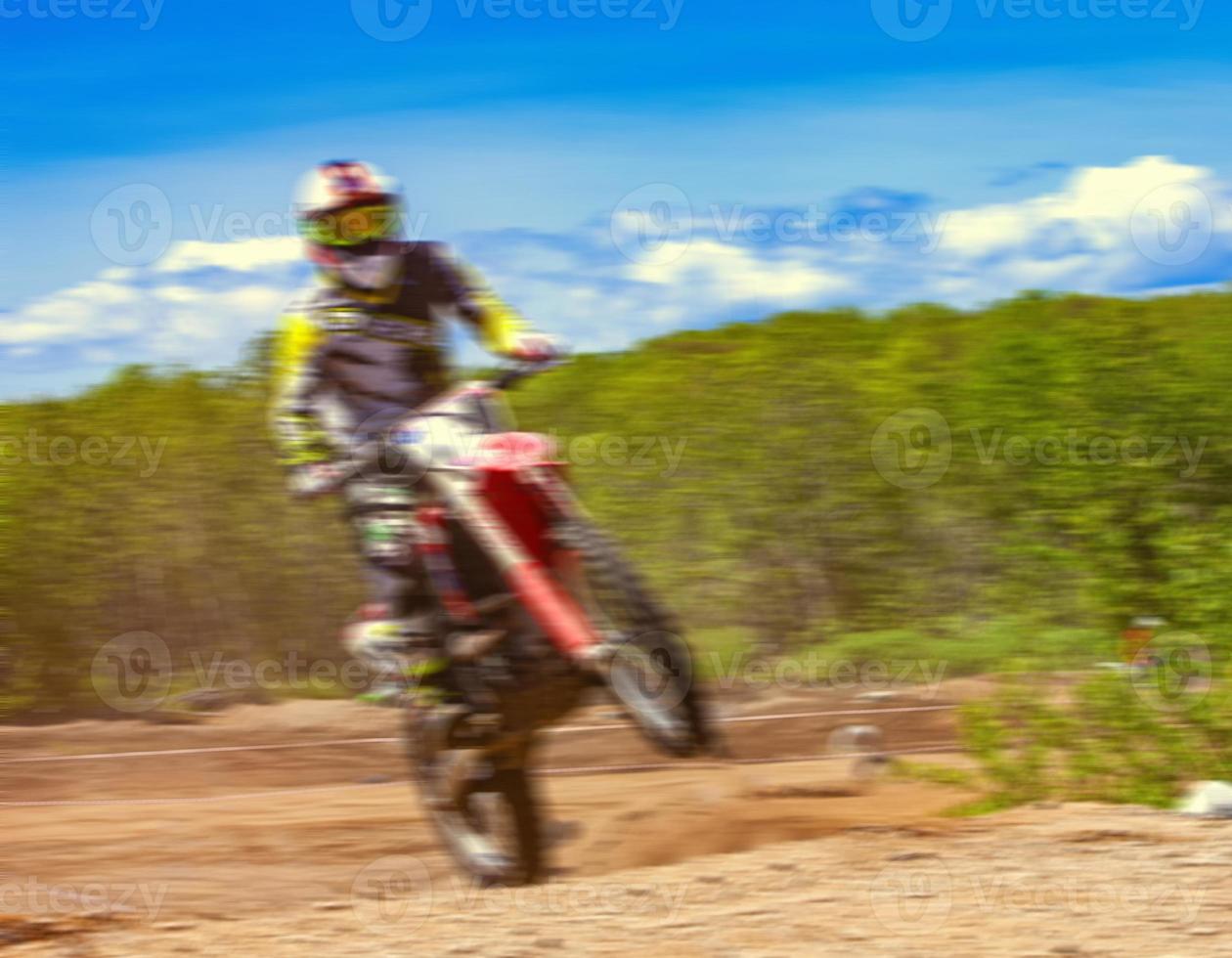 Motocross riders practice tricks on their dirt bikes on a sunny day in Kamchatka photo