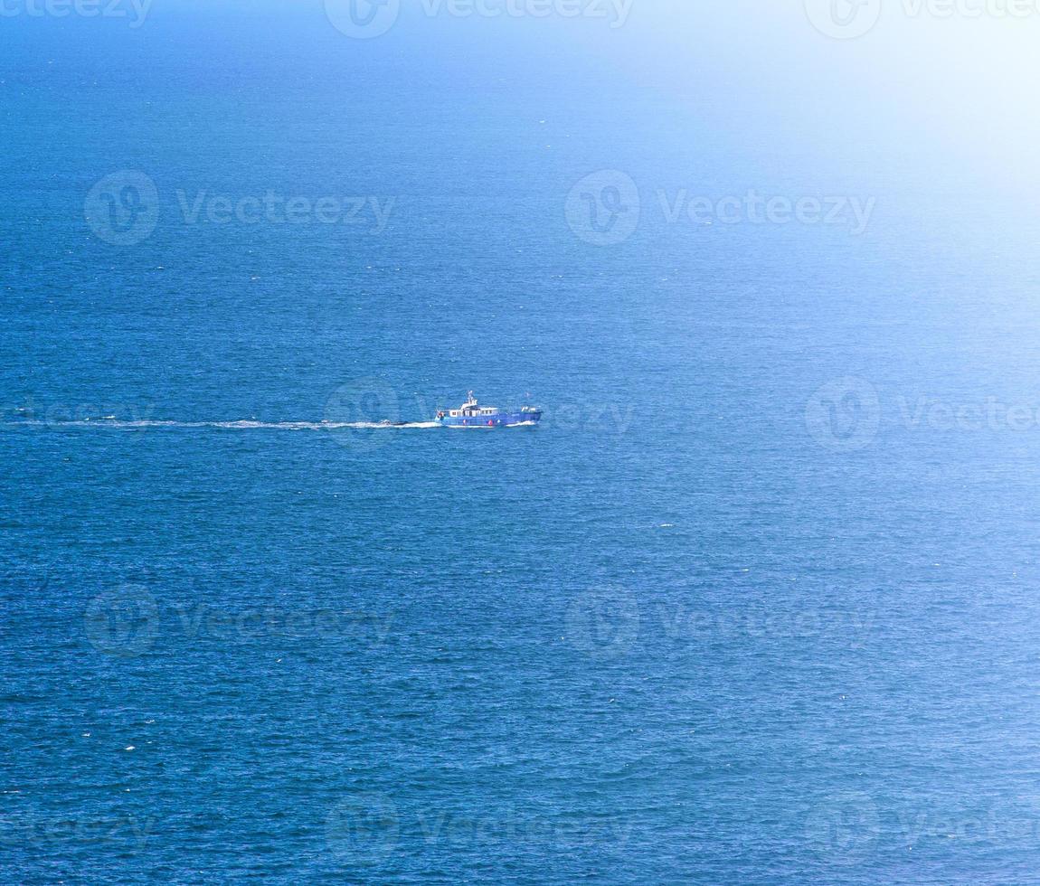 blue ocean waves and yacht photo