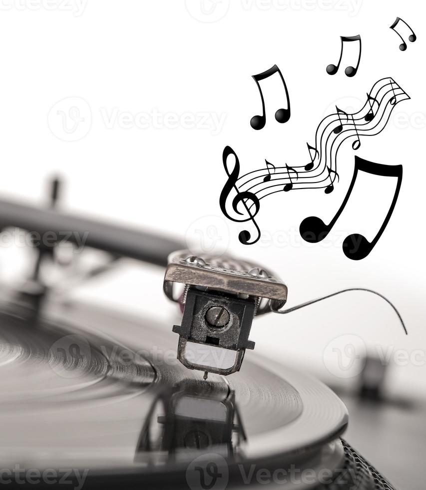 Old dusty vinyl turntable player isolated over white background. photo