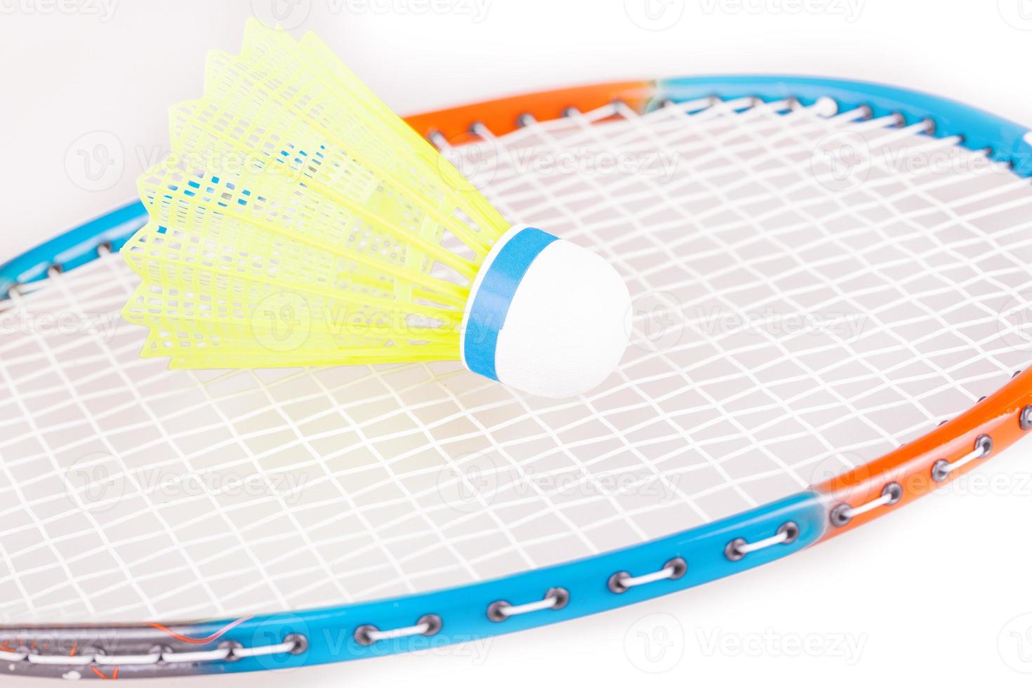 The Shuttlecock on badminton racket closeup photo