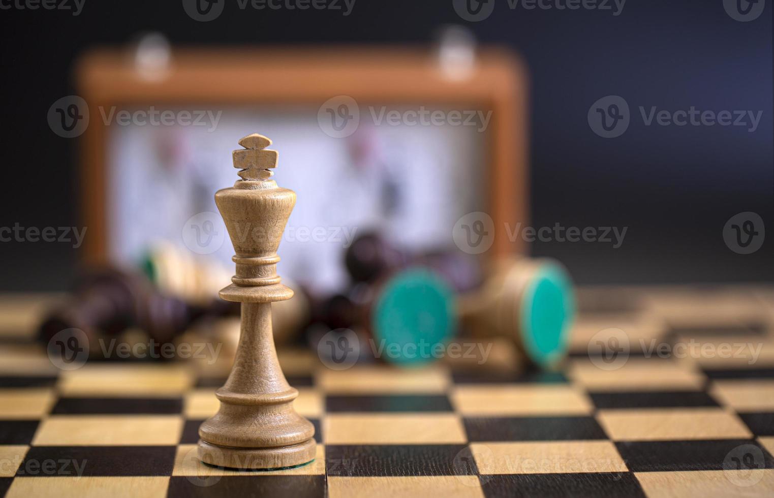 Chess pieces on a board and a chess clock on a dark background 16902564