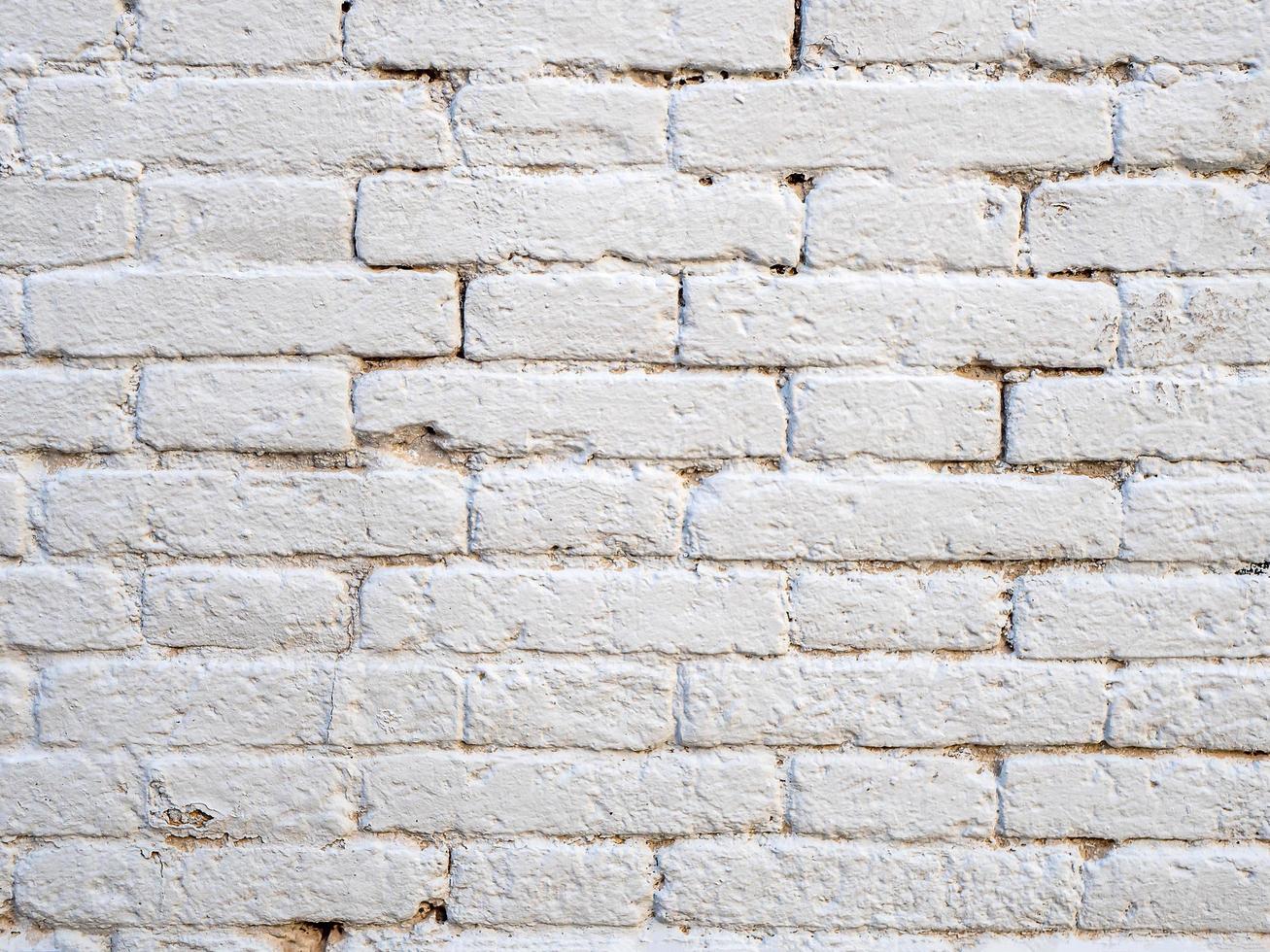 Grunge painted white rough brick wall abstract texture photo