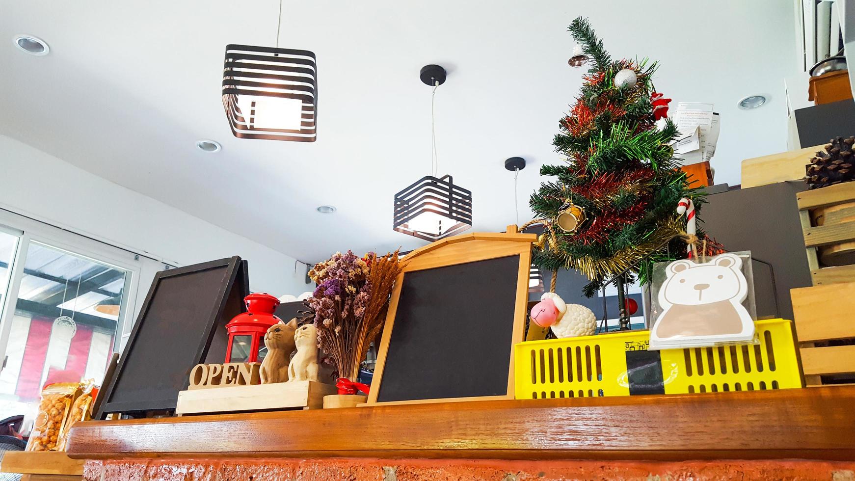 Stuffs on the couunter including small blackboard toys dolls and artificial trees photo
