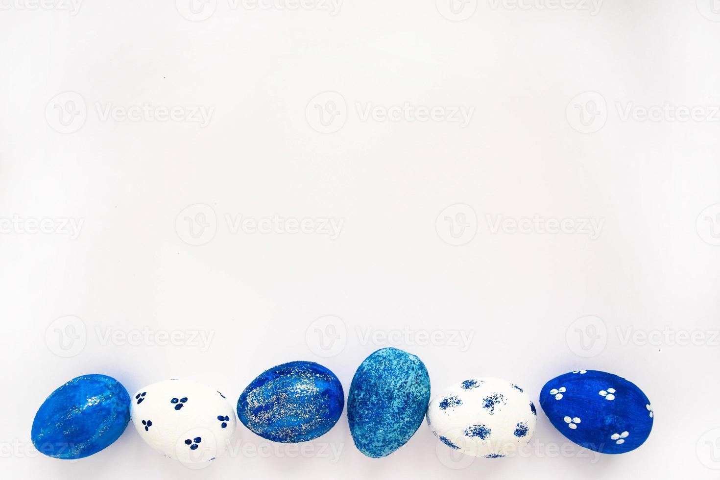 Happy Easter card. Frame with white and blue speckled easter eggs with copy space for text. photo