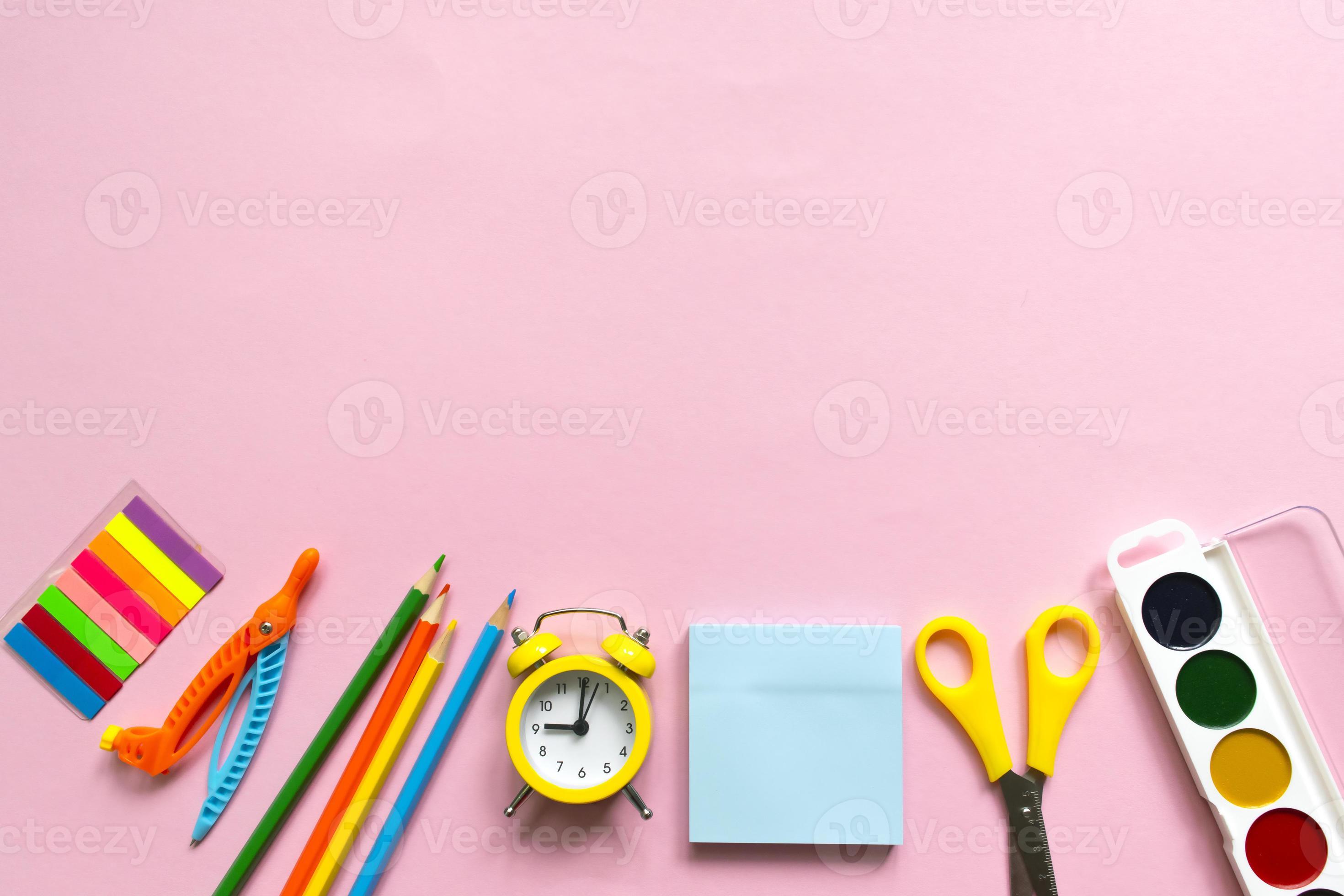 Back to school background. School accessories on a pink background