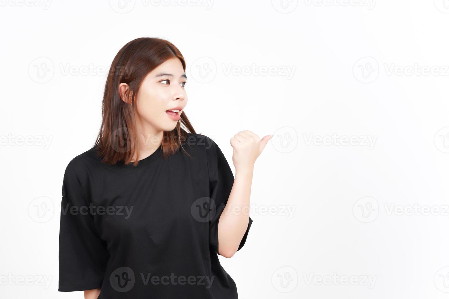 Presenting and Pointing Side Product Using Thumb Of Beautiful Asian Woman Isolated On White photo