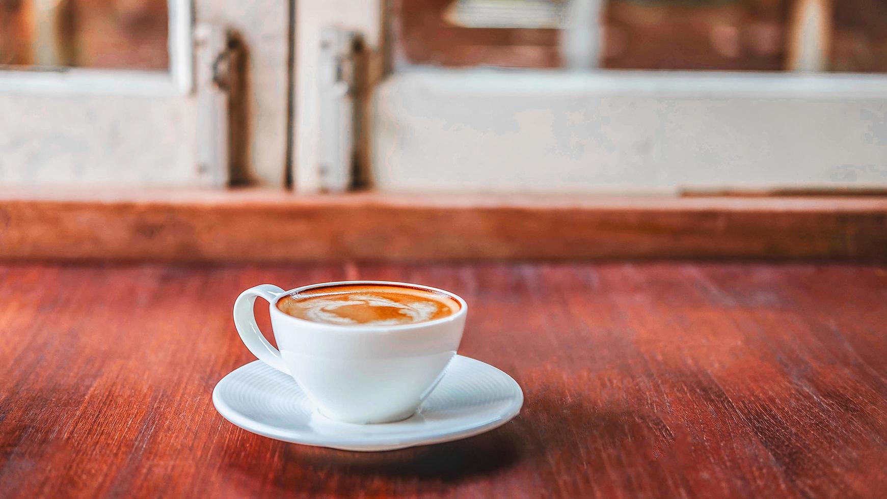 A cup of coffee on wooden table in coffee shop 16929849 Stock Photo at