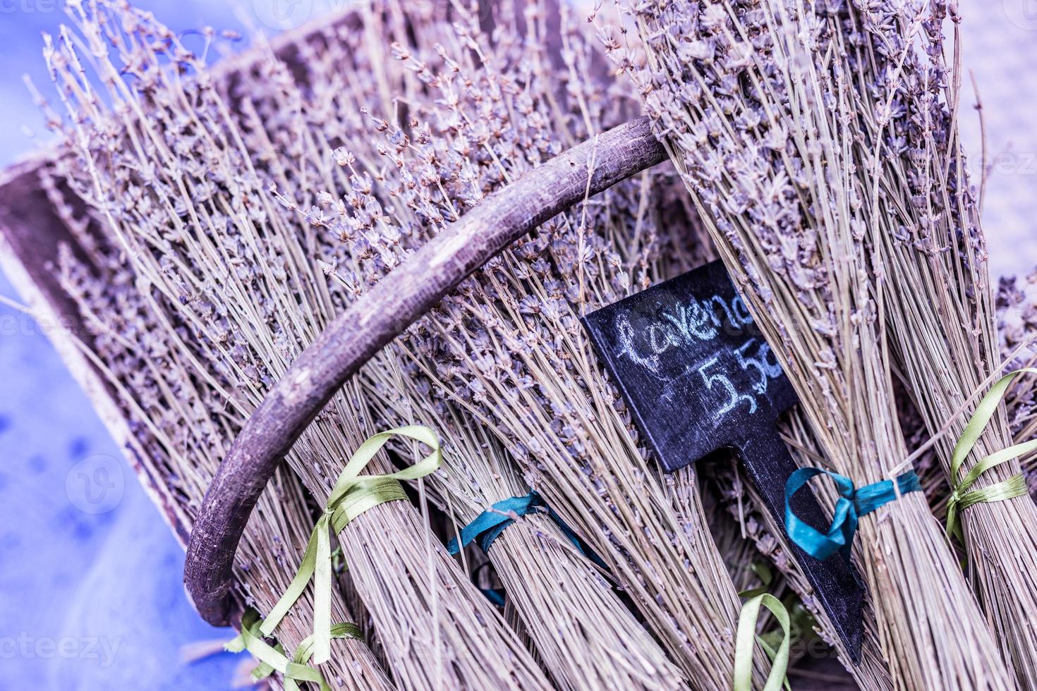 Lavender in a basket, lavender on the counter street. Bunch bouquet of fresh lavender in a wooden chair. photo