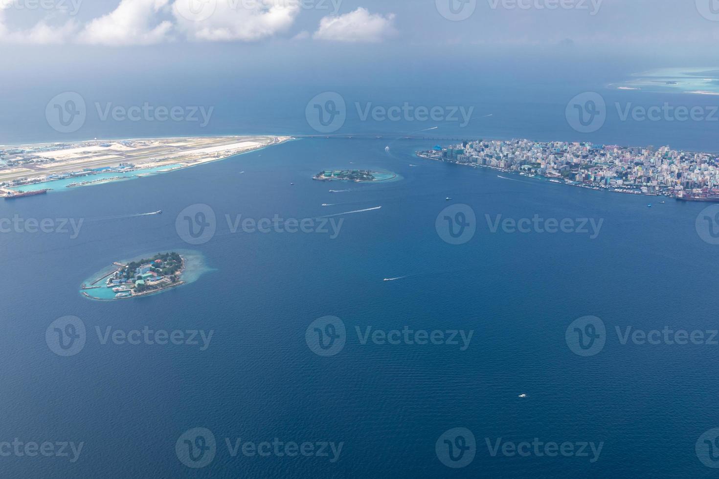 Aerial view of Maldives islands and atolls. Maldives tourism and travel background. Amazing blue sea, coral reef and atoll drone view. Beautiful nature landscape, seascape, exotic destination photo
