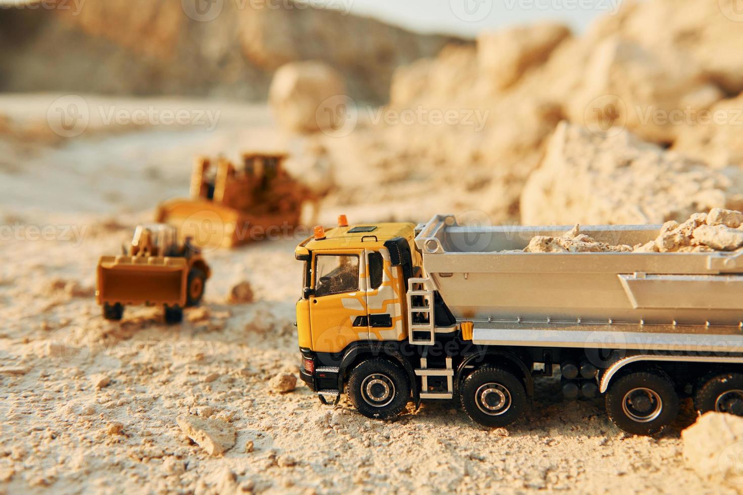 Loading vehicle miniatures outdoors on the borrow pit at daytime photo