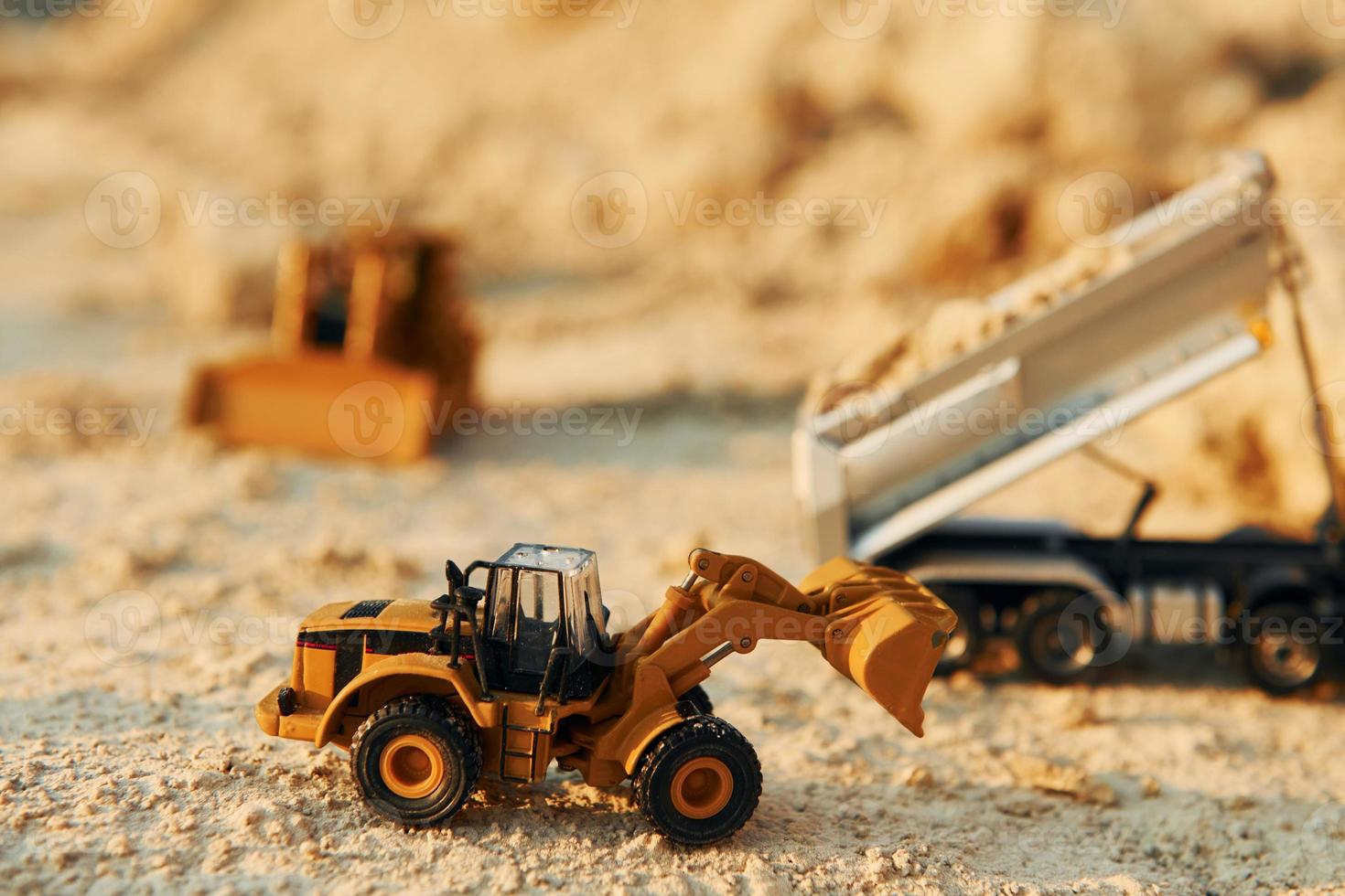 Loading vehicle miniatures outdoors on the borrow pit at daytime photo