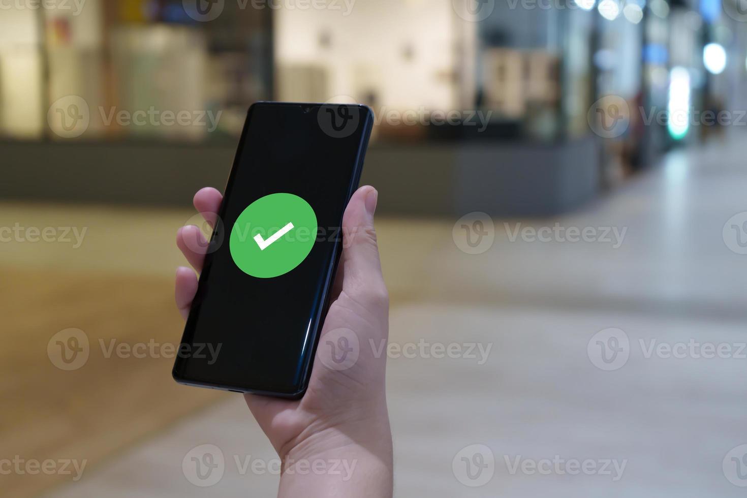 Hand holding mobile smart phone with verification. validation process. cyber security safe data protection. photo