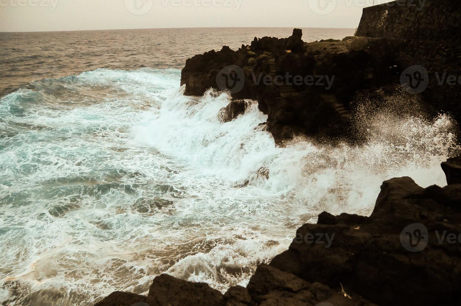 Big waves hitting the rocks photo