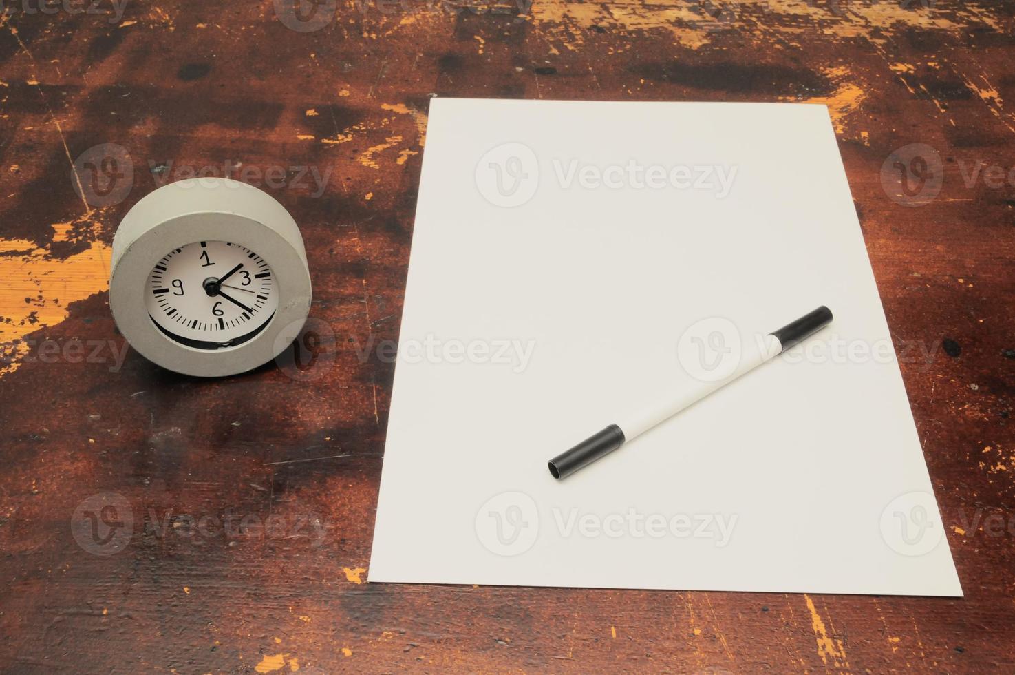 Pencil and paper on the table photo