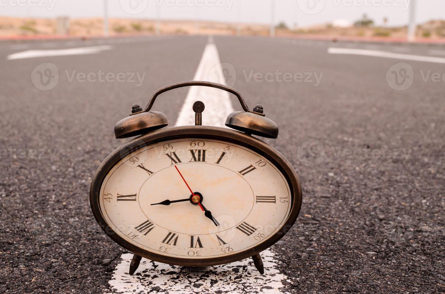 Clock on the road photo