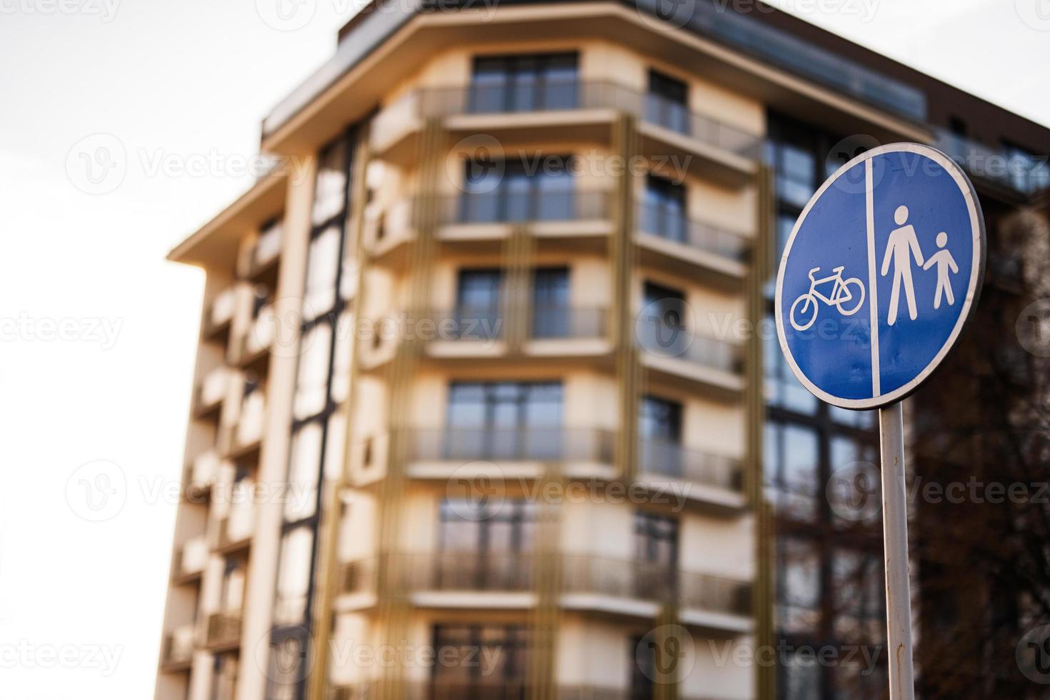 señal de tráfico en frente de la zona de peatones y bicicletas contra el edificio. foto