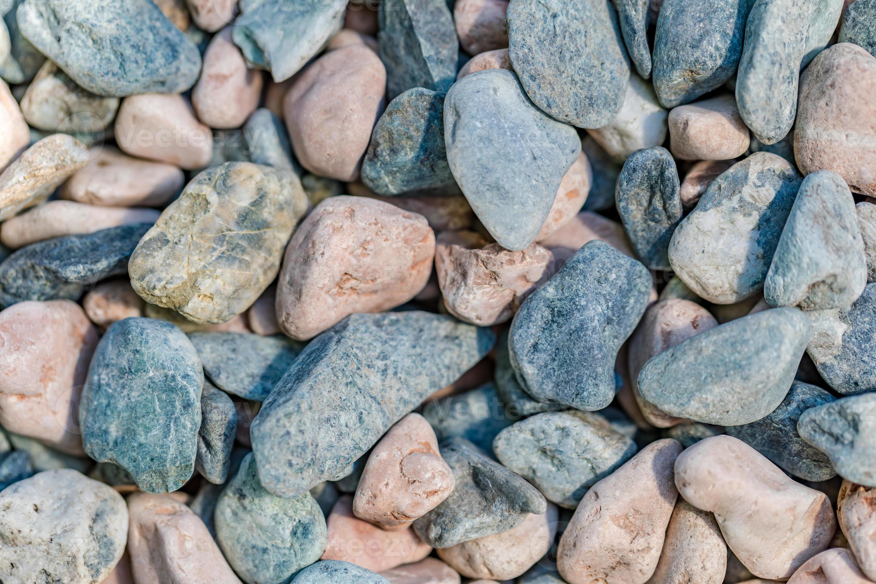 Dry pebbles closeup on beach. Bright red and blue pebbles, rocks