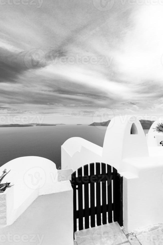 Classical view in Oia village on Santorini volcano island in Greece. Dramatic process, black and white photo. Caldera sea view, idyllic landscape photo