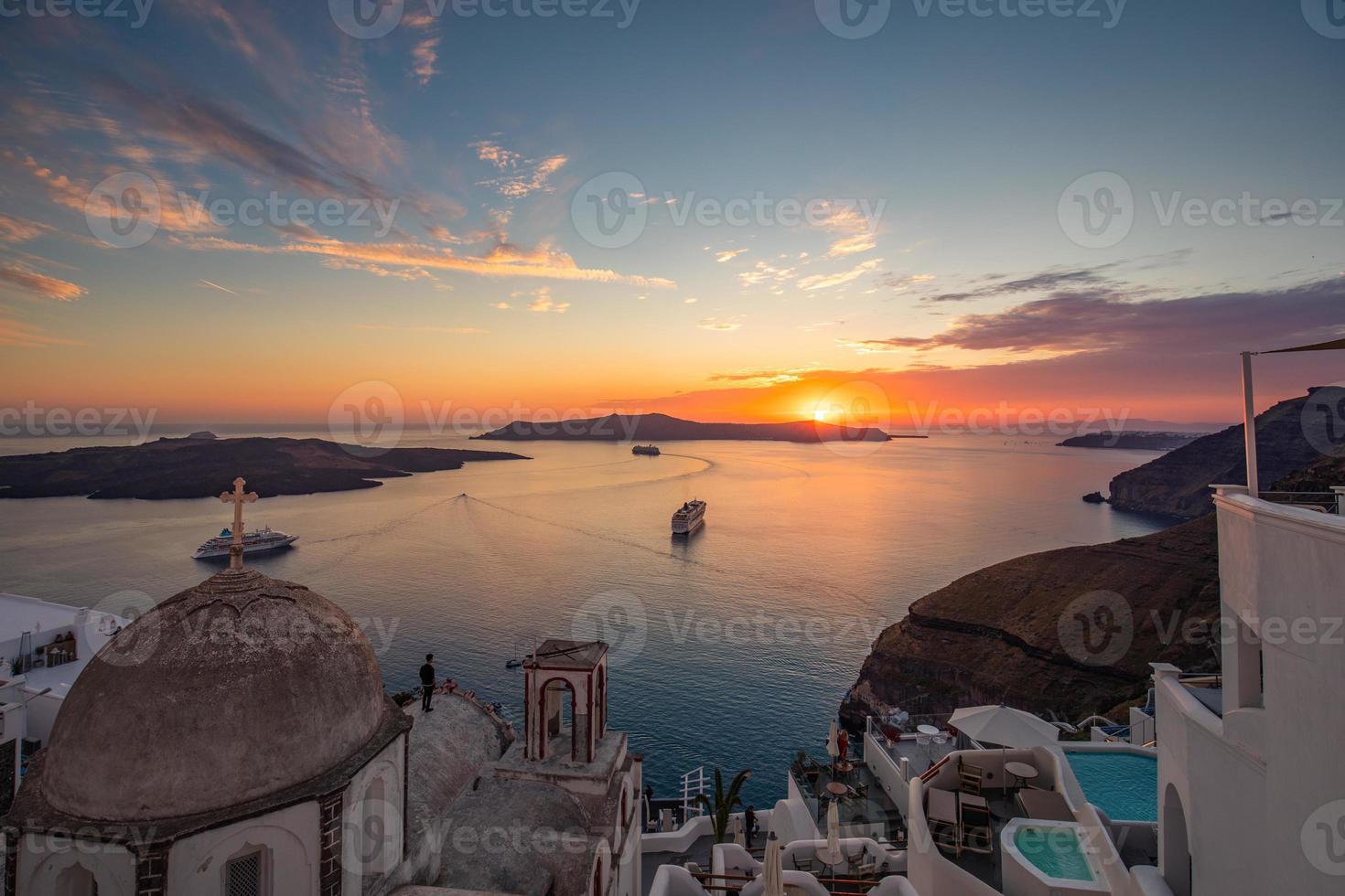 Tranquil evening view of Santorini island. Picturesque spring sunset on the famous Greek resort Fira, Greece, Europe. Summer vacation. Traveling concept background. Artistic style post processed photo