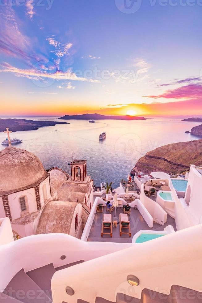 Amazing evening view of Santorini island. Picturesque spring sunset on the famous Greek resort Fira, Greece, Europe. Traveling concept background. Artistic style post processed photo. Summer vacation photo