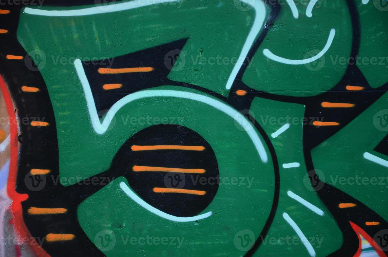 Fragment of graffiti drawings. The old wall decorated with paint stains in the style of street art culture. Colored background texture in green tones photo