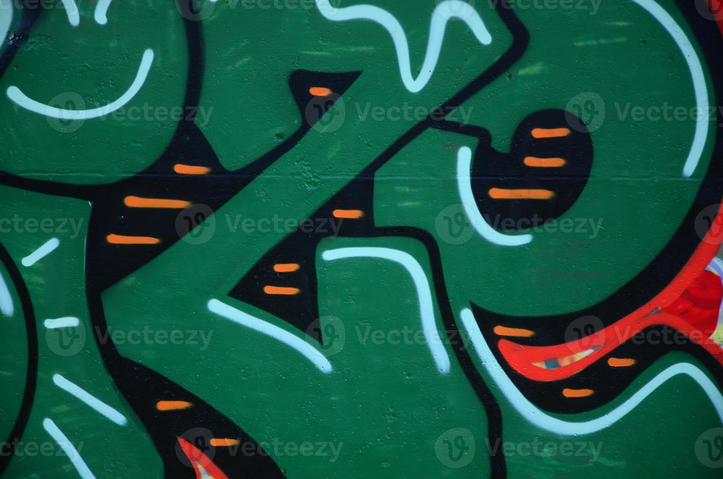 Fragment of graffiti drawings. The old wall decorated with paint stains in the style of street art culture. Colored background texture in green tones photo