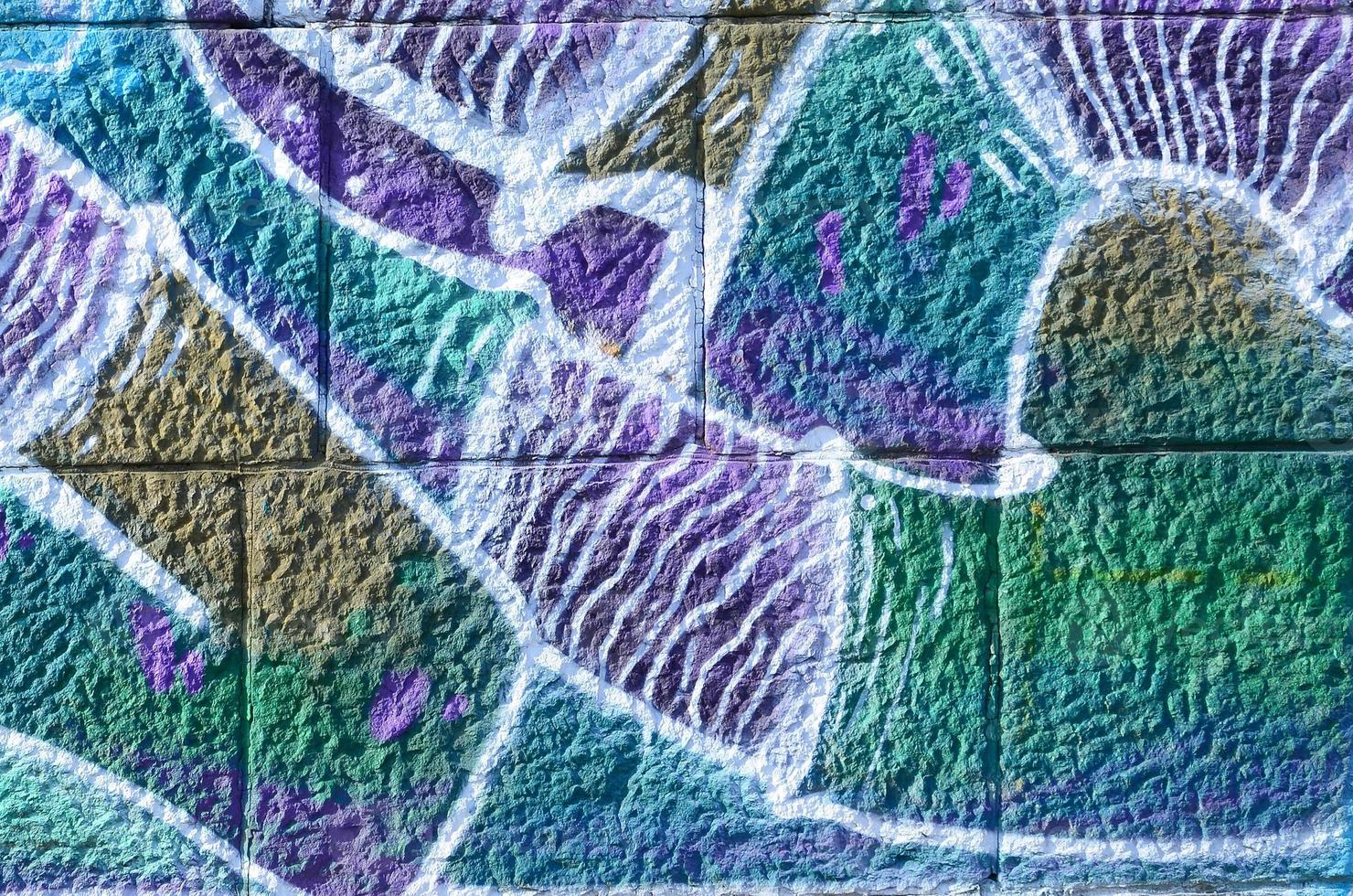 Fragment of graffiti drawings. The old wall decorated with paint stains in the style of street art culture. Colored background texture in cold tones photo