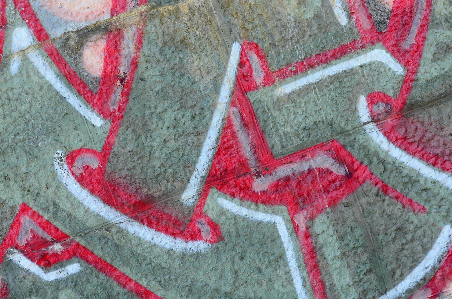 Fragment of graffiti drawings. The old wall decorated with paint stains in the style of street art culture. Colored background texture in warm tones photo