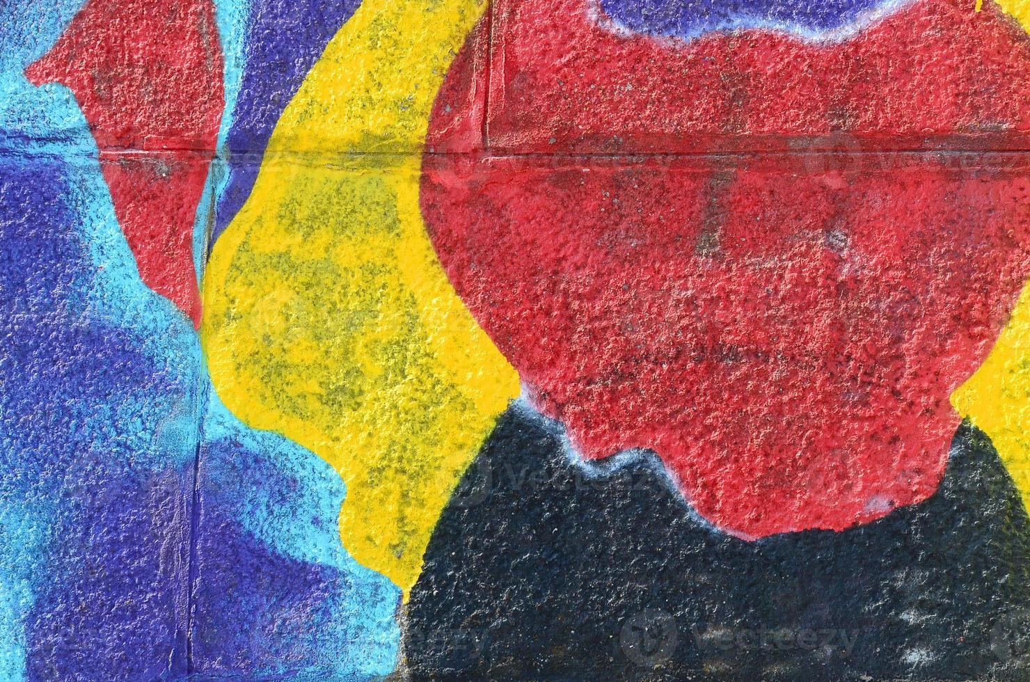 Fragment of graffiti drawings. The old wall decorated with paint stains in the style of street art culture. Multicolored background texture photo
