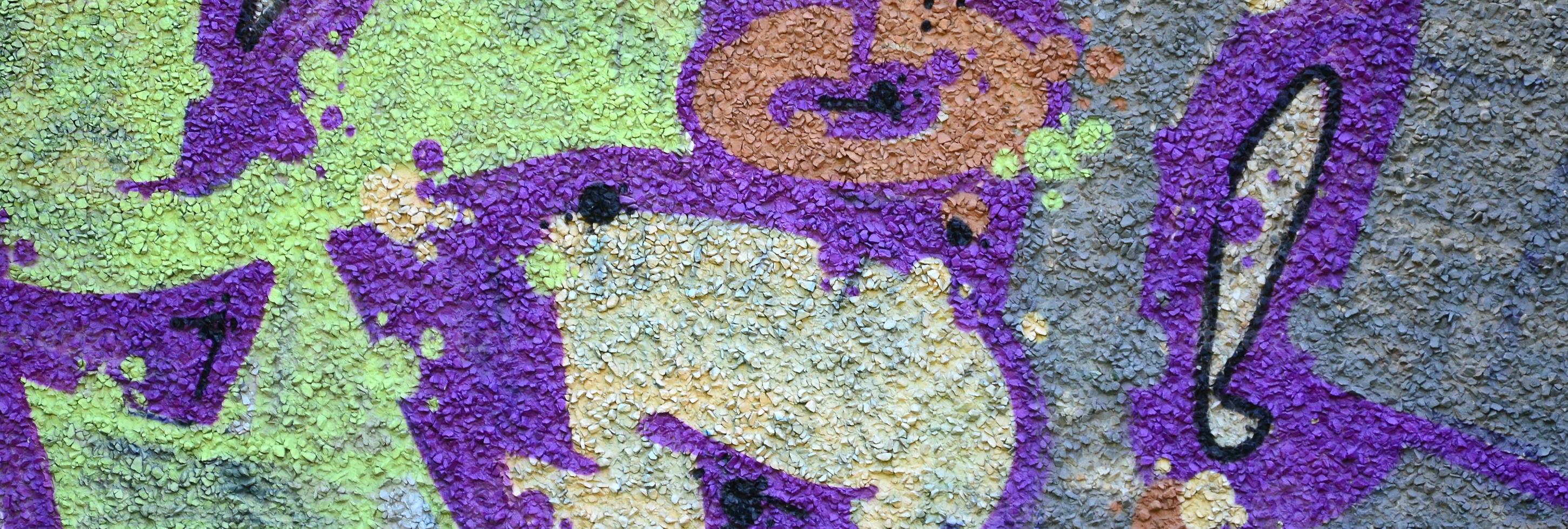 fragmento de dibujos de graffiti. la antigua muralla decorada con manchas de pintura al estilo de la cultura del arte callejero. textura de fondo coloreada en tonos cálidos foto