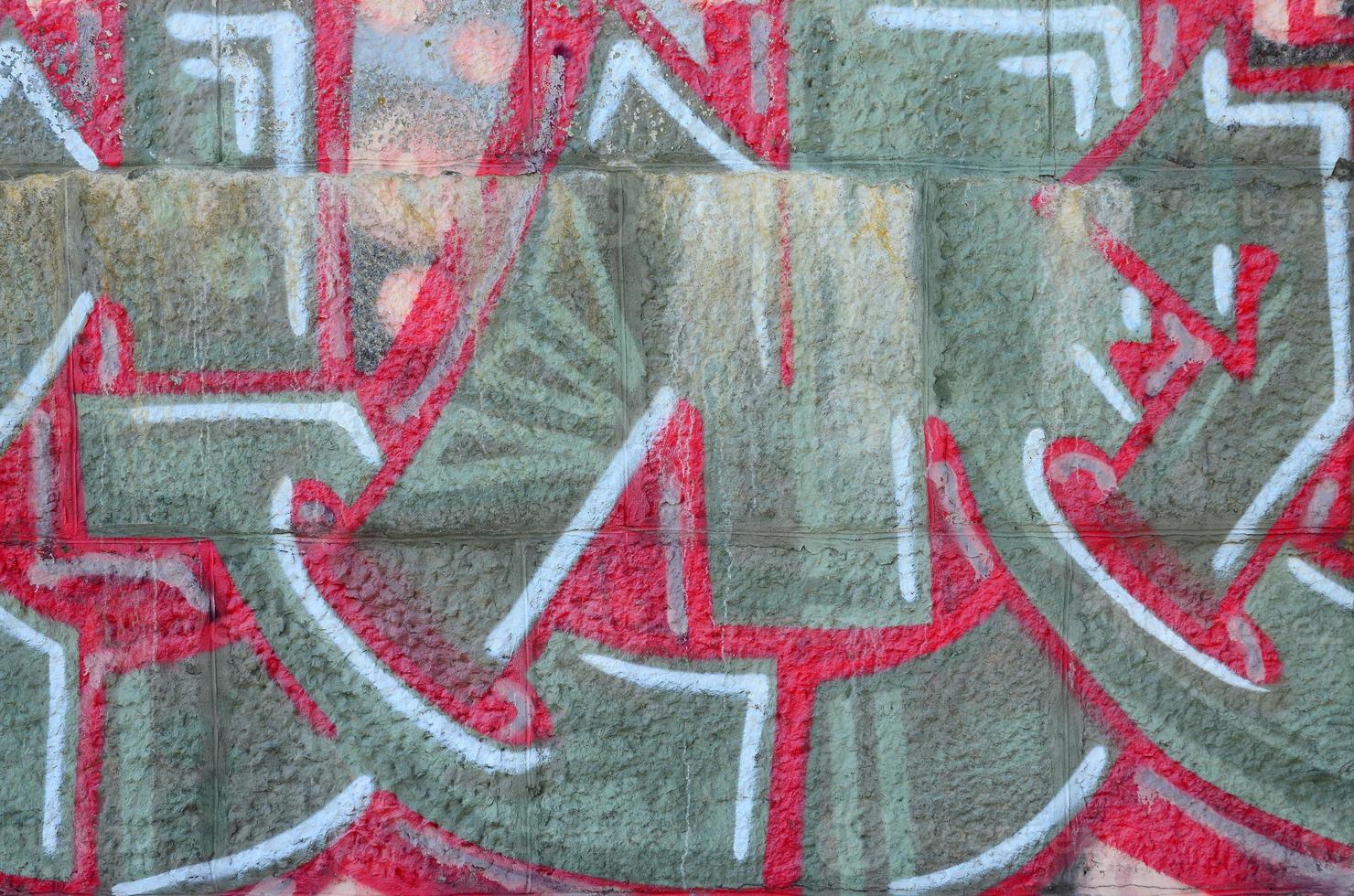 Fragment of graffiti drawings. The old wall decorated with paint stains in the style of street art culture. Colored background texture in warm tones photo