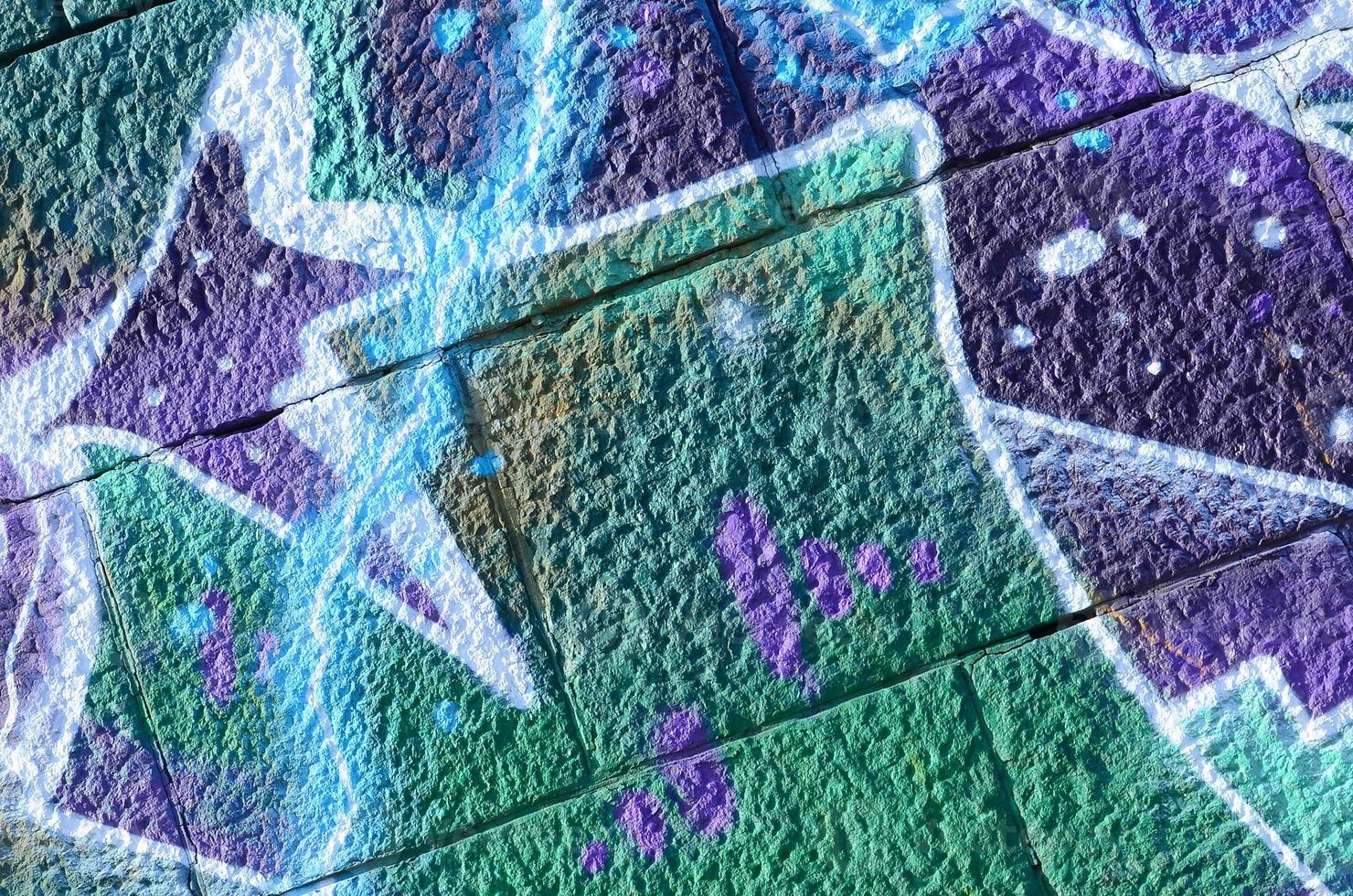 Fragment of graffiti drawings. The old wall decorated with paint stains in the style of street art culture. Colored background texture in cold tones photo