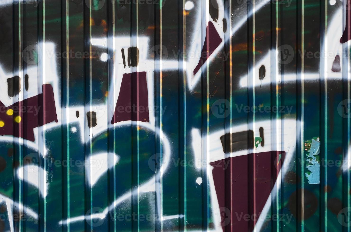Fragment of graffiti drawings. The old wall decorated with paint stains in the style of street art culture. Colored background texture in green tones photo
