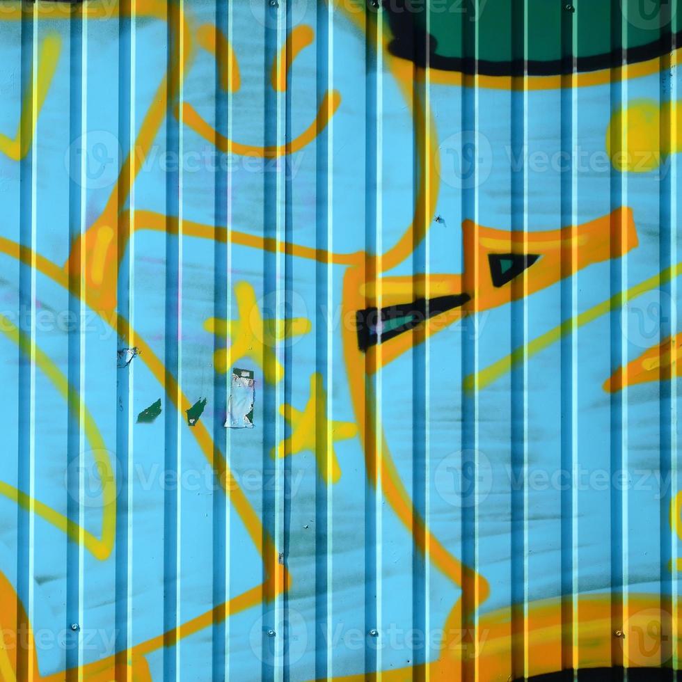 Fragment of graffiti drawings. The old wall decorated with paint stains in the style of street art culture. Colored background texture in cold tones photo