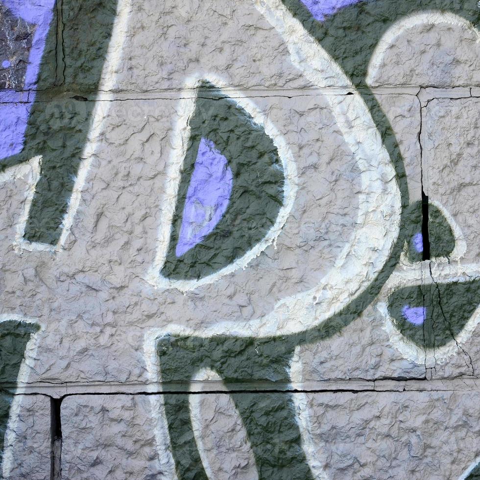 Fragment of graffiti drawings. The old wall decorated with paint stains in the style of street art culture. Colored background texture in purple tones photo