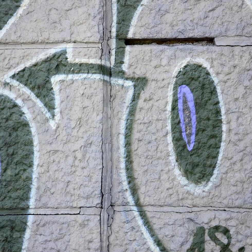 Fragment of graffiti drawings. The old wall decorated with paint stains in the style of street art culture. Colored background texture in purple tones photo