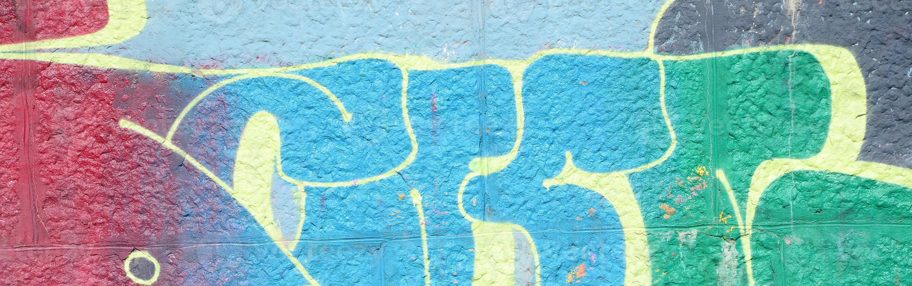 Fragment of graffiti drawings. The old wall decorated with paint stains in the style of street art culture. Colored background texture in cold tones photo