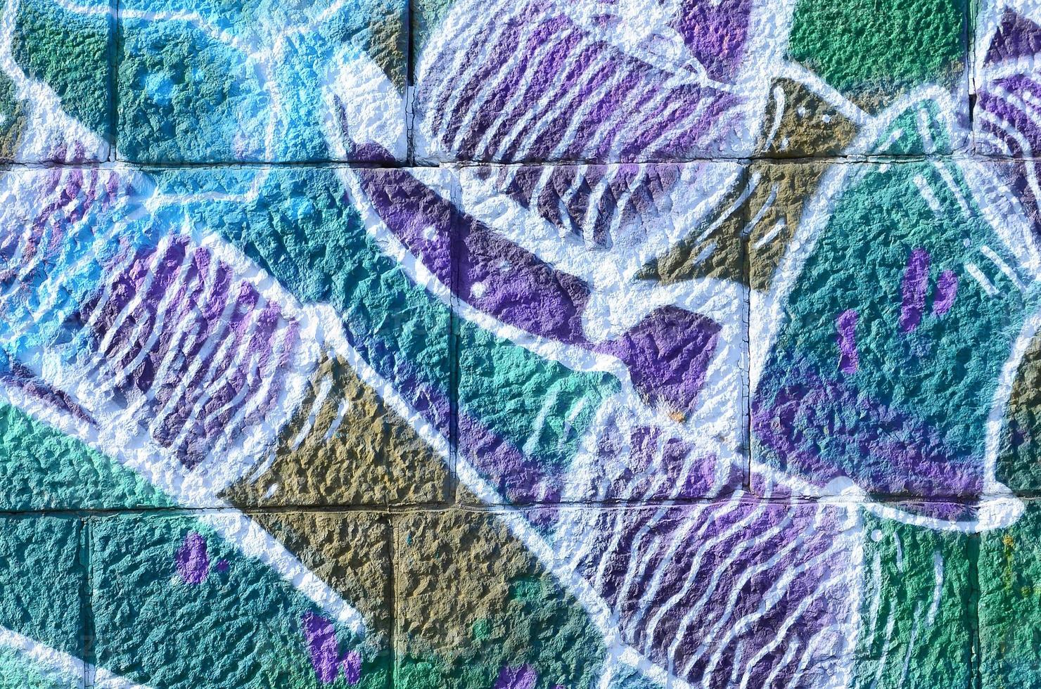 Fragment of graffiti drawings. The old wall decorated with paint stains in the style of street art culture. Colored background texture in cold tones photo