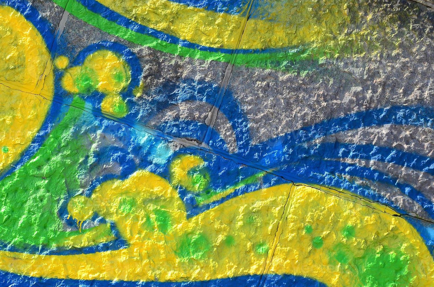 Fragment of graffiti drawings. The old wall decorated with paint stains in the style of street art culture. Colored background texture in green tones photo