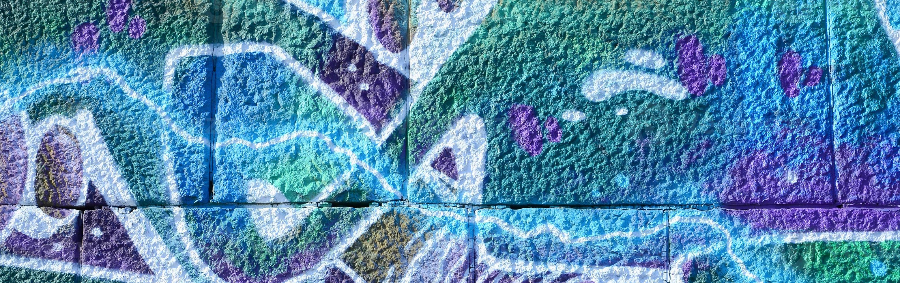 Fragment of graffiti drawings. The old wall decorated with paint stains in the style of street art culture. Colored background texture in cold tones photo