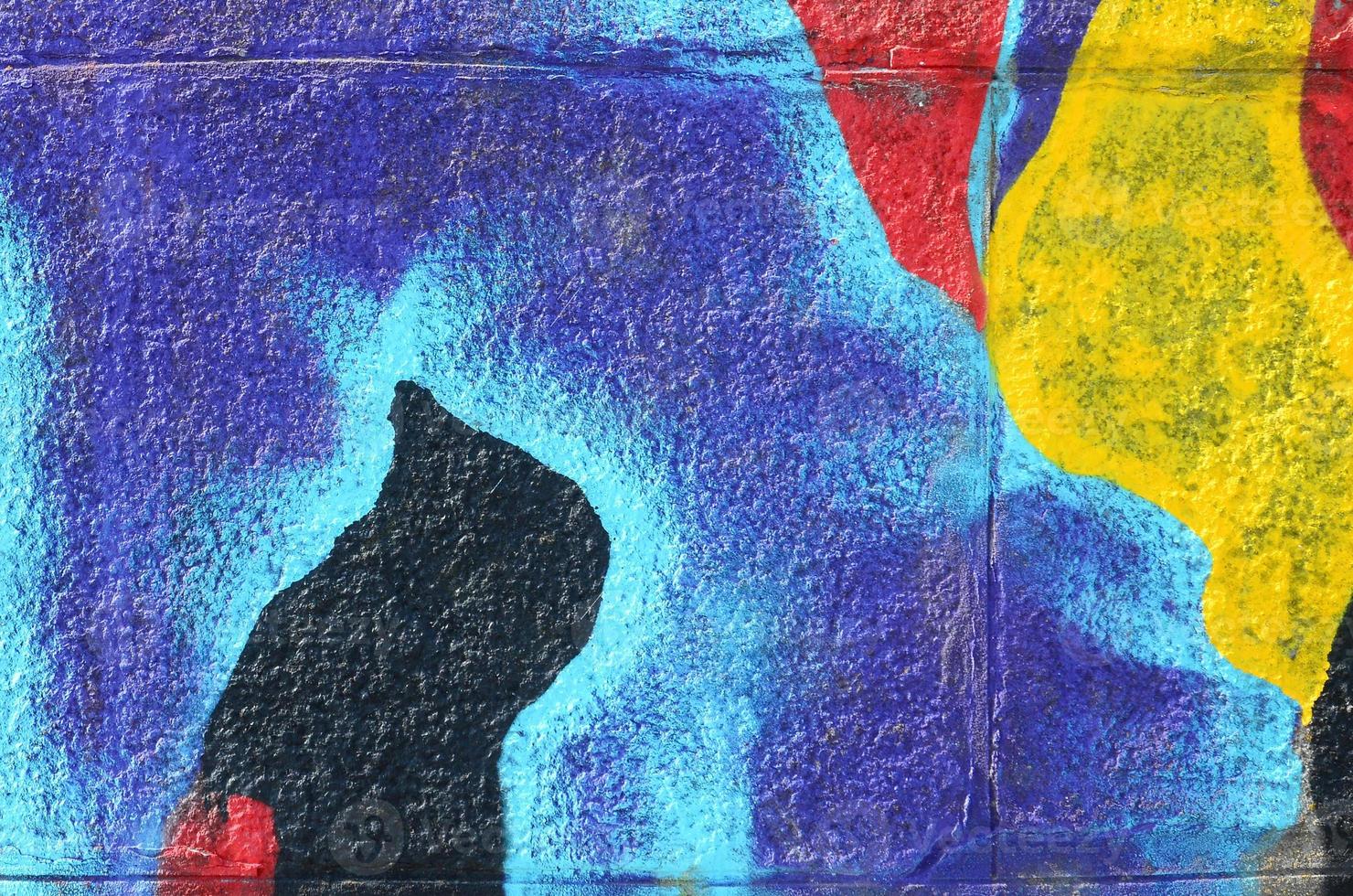 Fragment of graffiti drawings. The old wall decorated with paint stains in the style of street art culture. Multicolored background texture photo