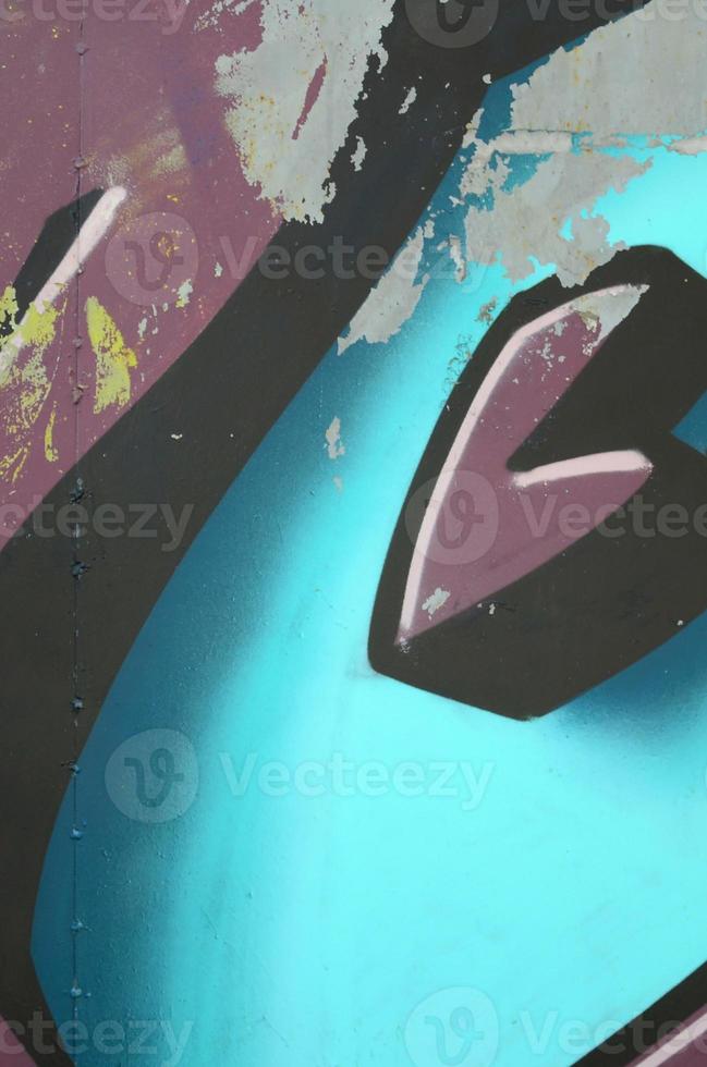 Fragment of graffiti drawings. The old wall decorated with paint stains in the style of street art culture. Colored background texture in cold tones photo