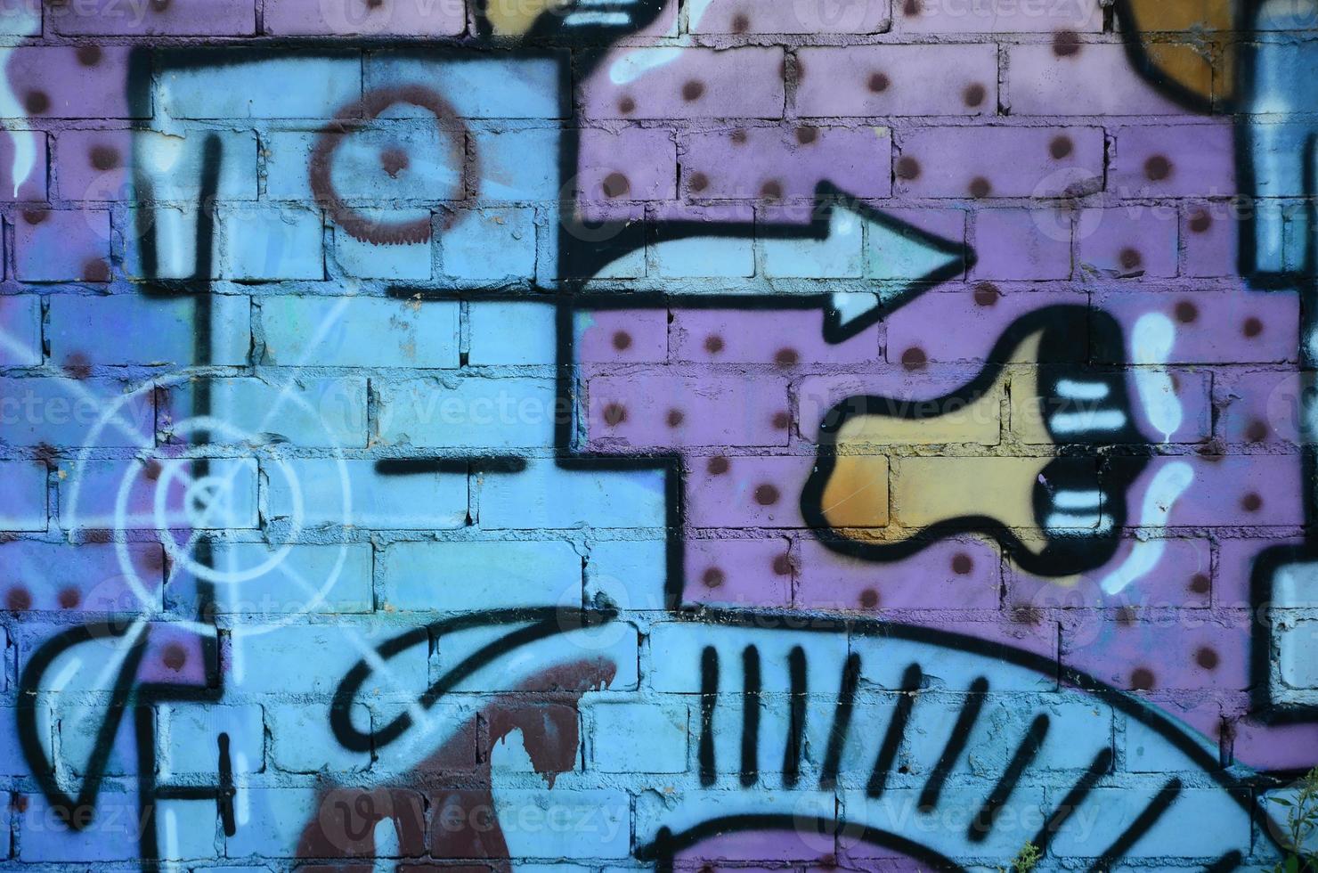 Fragment of graffiti drawings. The old wall decorated with paint stains in the style of street art culture. Colored background texture in cold tones photo