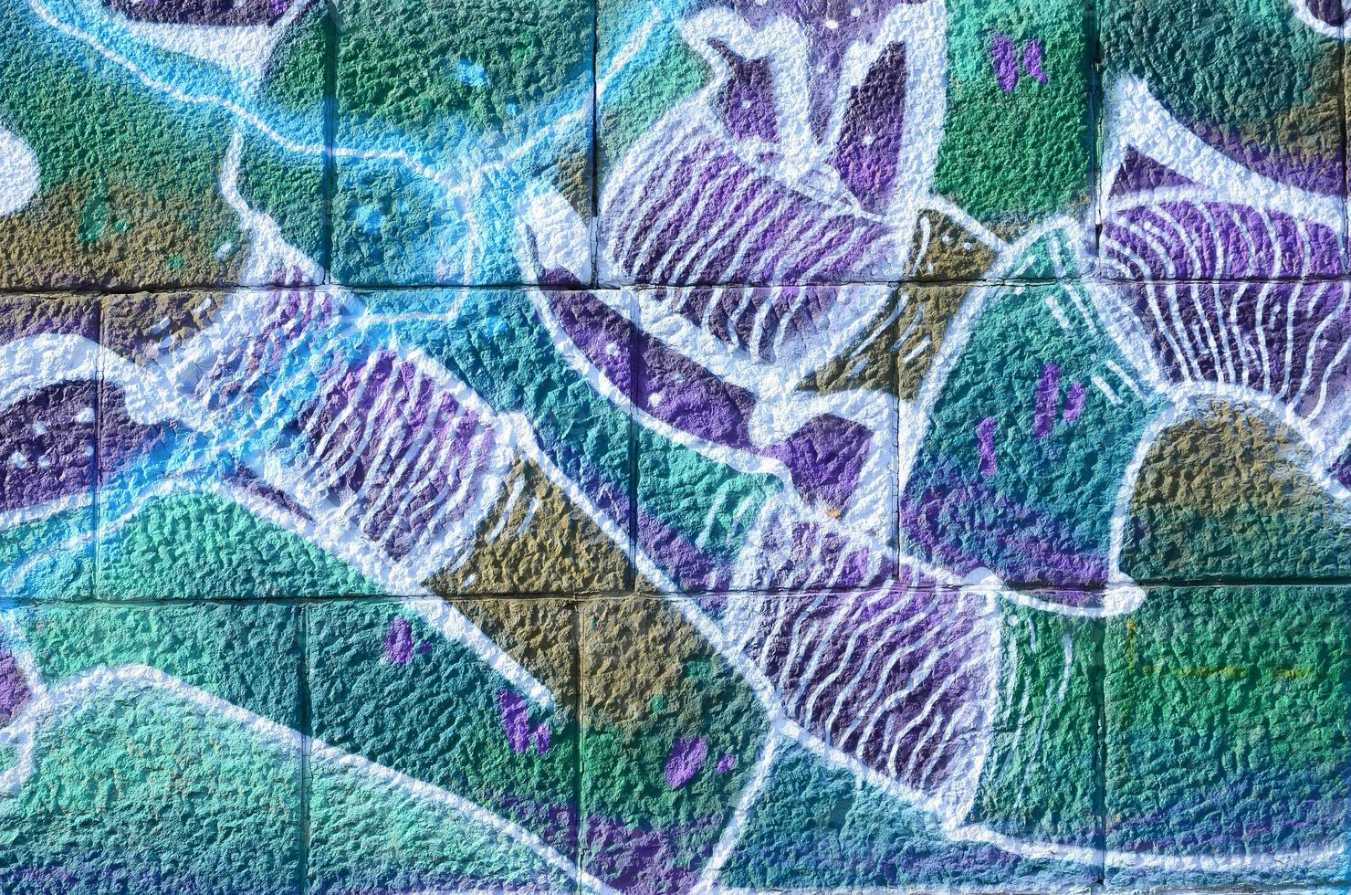Fragment of graffiti drawings. The old wall decorated with paint stains in the style of street art culture. Colored background texture in cold tones photo