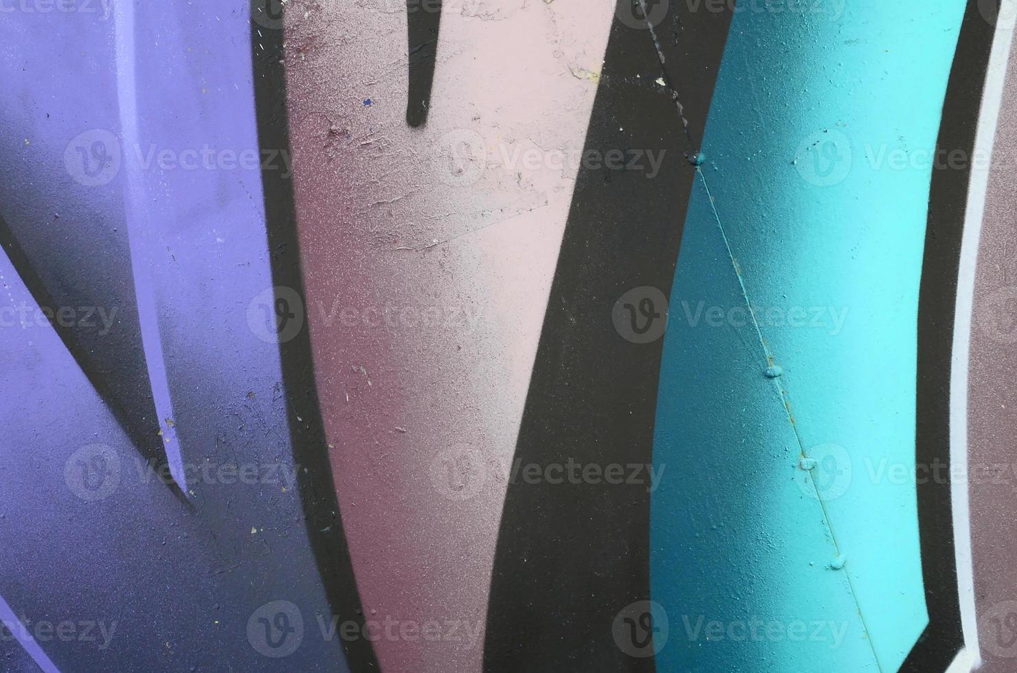 Fragment of graffiti drawings. The old wall decorated with paint stains in the style of street art culture. Colored background texture in cold tones photo